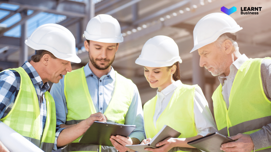 Construction workers reviewing digital training materials on-site, improving safety compliance, efficiency, and workforce readiness in Australia.