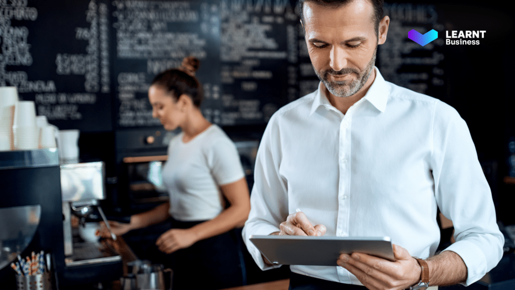 A restaurant manager conducting a digital training session for hospitality staff, ensuring better service and efficiency.